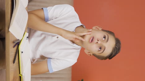 Vertical-video-of-Boy-focused-on-thinking.